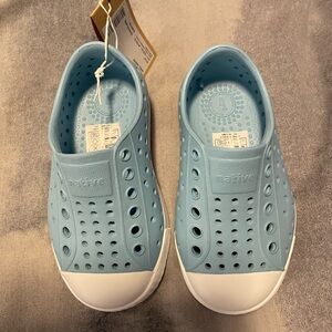 Native toddler shoes never worn. Still in box. Sky blue/white shell. Size C6.